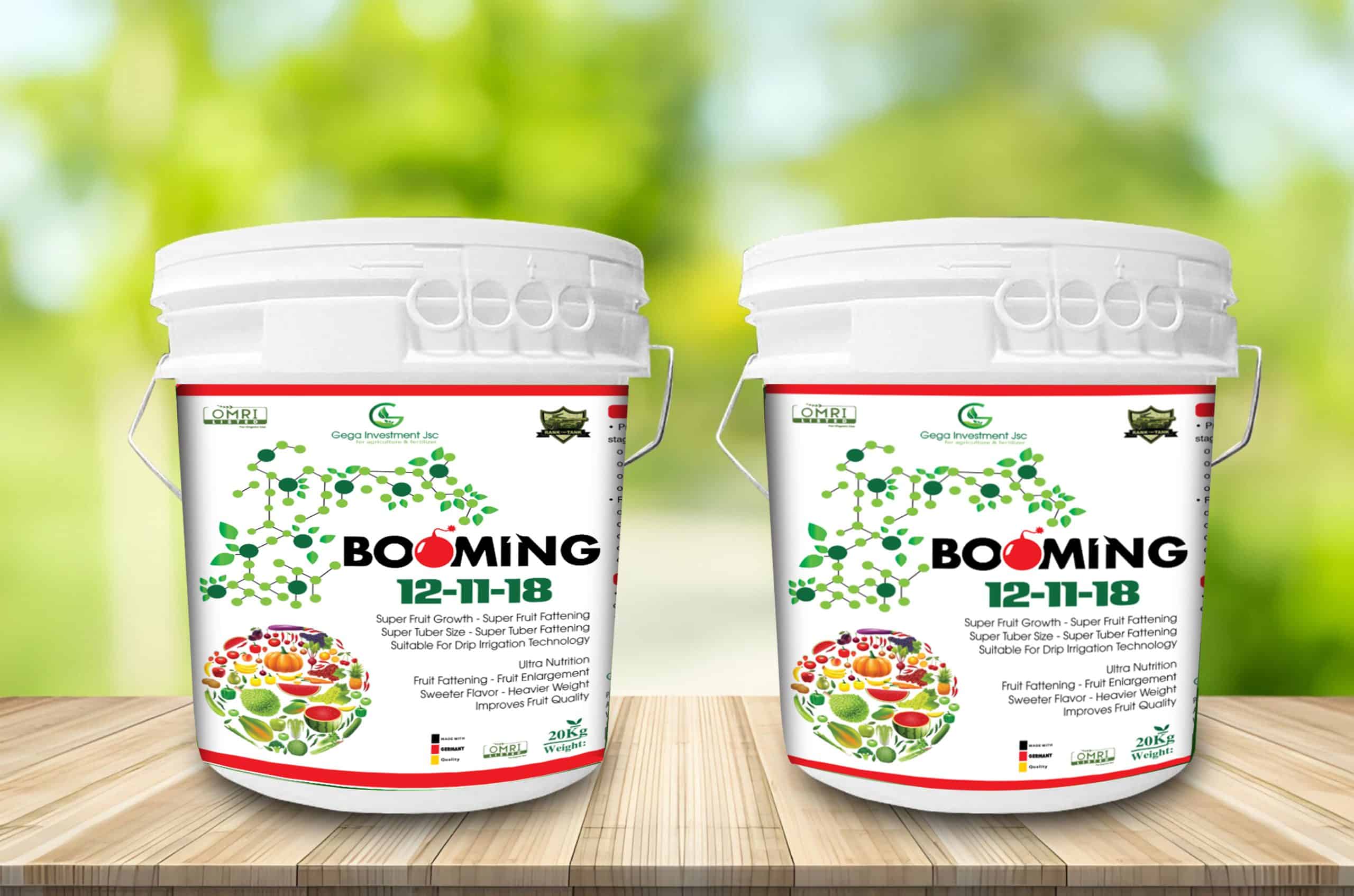 Booming 12-11-18 fertilizer buckets — white 20 kg containers with green molecular pattern and fruit imagery, packaging design by Silver Lotus for Vietnamese agricultural brand Gega Investment.